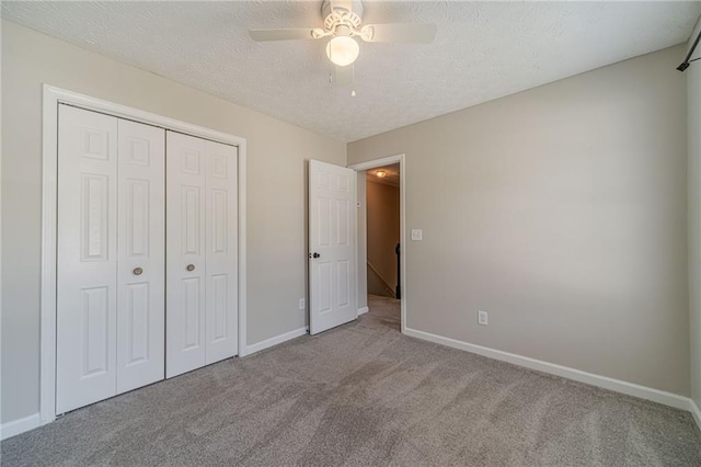 206 Belmont Dr, Monroe, GA 30655 - unfurnished bedroom featuring carpet, baseboards, a closet, and a textured ceiling