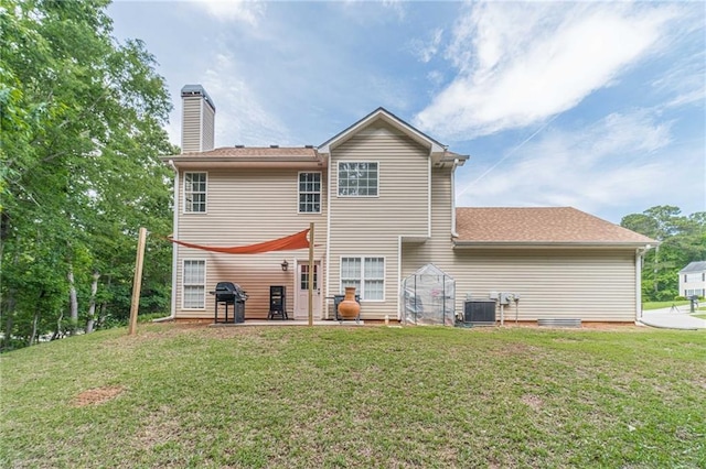 206 Belmont Dr, Monroe, GA 30655 - back of property featuring a patio, a lawn, a chimney, and central AC