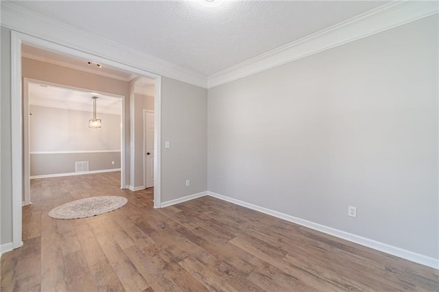 206 Belmont Dr, Monroe, GA 30655 - spare room featuring wood finished floors, crown molding, and baseboards