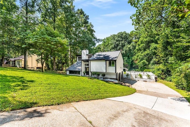 5219 Legendary Ln, Acworth, GA 30102 - view of front of home featuring concrete driveway, a front lawn, and a chimney