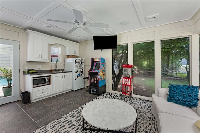 5219 Legendary Ln, Acworth, GA 30102 - kitchen featuring freestanding refrigerator, stainless steel microwave, dark countertops, dark tile patterned flooring, and a ceiling fan