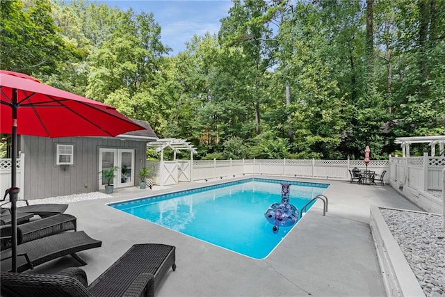 5219 Legendary Ln, Acworth, GA 30102 - view of pool with french doors, a fenced backyard, a patio area, view of wooded area, and a storage structure