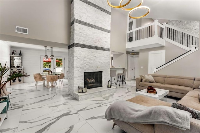 5219 Legendary Ln, Acworth, GA 30102 - living room with a towering ceiling, marble finish flooring, stairway, and a stone fireplace