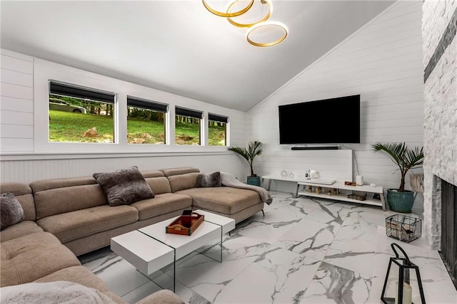 5219 Legendary Ln, Acworth, GA 30102 - living room featuring vaulted ceiling, wooden walls, marble look tiles, and a fireplace