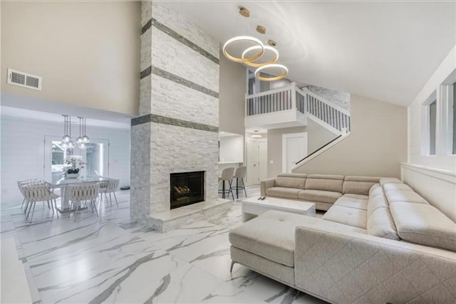 5219 Legendary Ln, Acworth, GA 30102 - living area featuring high vaulted ceiling, a chandelier, a fireplace, and marble finish flooring