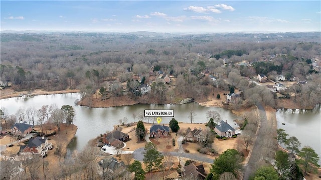 drone / aerial view with a water view and a wooded view