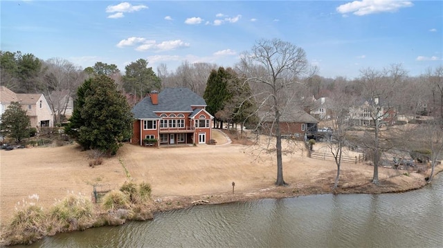 back of house featuring a deck with water view