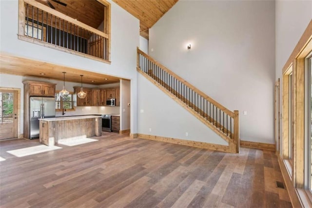 78 Pocola Ct, Ellijay, GA 30536 - unfurnished living room with stairway, baseboards, a high ceiling, and wood finished floors