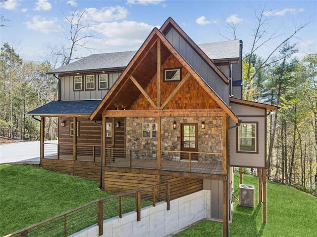 78 Pocola Ct, Ellijay, GA 30536 - view of front of home featuring board and batten siding, covered porch, roof with shingles, central air condition unit, and a front lawn