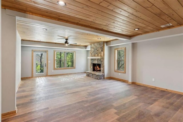 78 Pocola Ct, Ellijay, GA 30536 - unfurnished living room with wood ceiling, a ceiling fan, a stone fireplace, wood finished floors, and baseboards