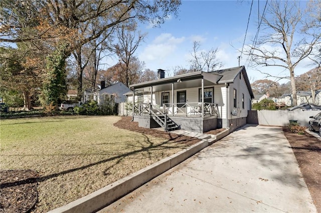 view of front of house with covered porch and a front yard