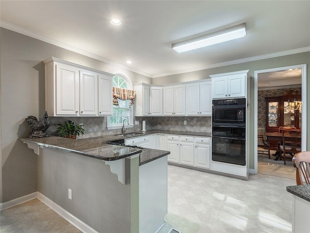 3580 Treeline Pass NE, Roswell, GA 30075 - kitchen with a peninsula, a kitchen breakfast bar, dark stone countertops, white cabinetry, and crown molding