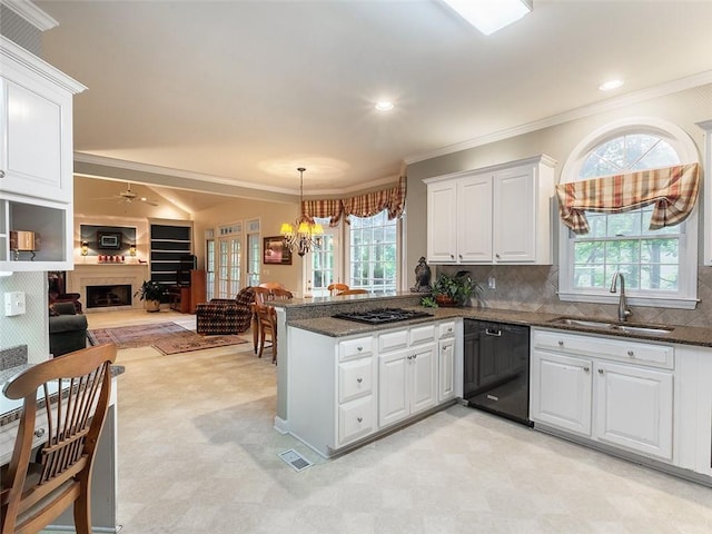 3580 Treeline Pass NE, Roswell, GA 30075 - kitchen with black dishwasher, a fireplace with raised hearth, light flooring, white cabinets, and ornamental molding