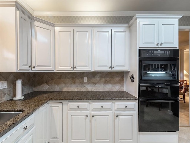 3580 Treeline Pass NE, Roswell, GA 30075 - kitchen featuring black oven, ornamental molding, dark stone countertops, decorative backsplash, and white cabinetry