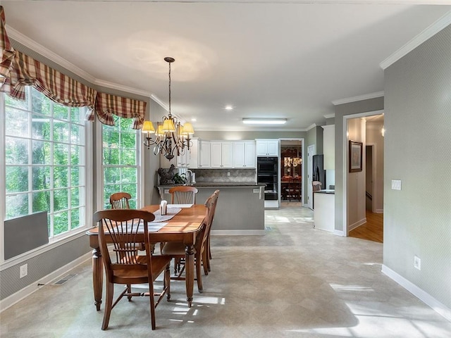 3580 Treeline Pass NE, Roswell, GA 30075 - dining space with a chandelier, ornamental molding, and light floors