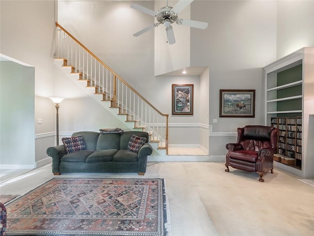 3580 Treeline Pass NE, Roswell, GA 30075 - carpeted living room with a towering ceiling, stairs, and ceiling fan