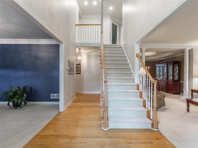 3580 Treeline Pass NE, Roswell, GA 30075 - staircase with ornate columns, a high ceiling, crown molding, wood finished floors, and carpet