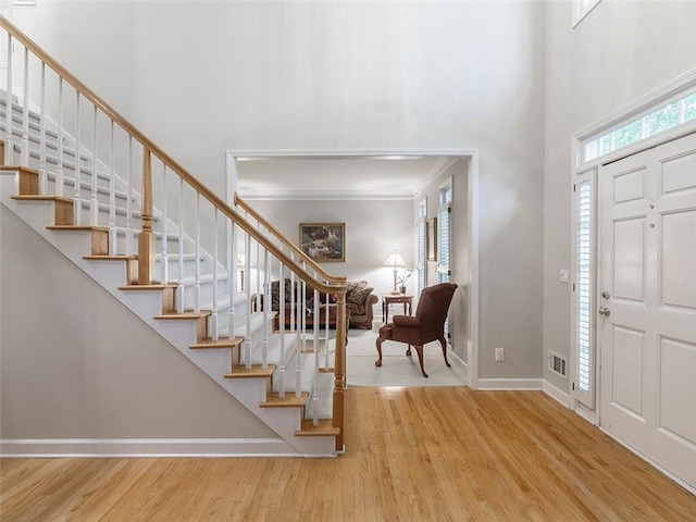 3580 Treeline Pass NE, Roswell, GA 30075 - foyer entrance featuring a high ceiling, wood finished floors, stairway, and ornamental molding