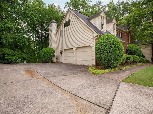 3580 Treeline Pass NE, Roswell, GA 30075 - view of property exterior with concrete driveway, an attached garage, and a chimney