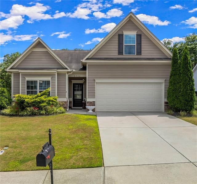 craftsman-style home with a front lawn and a garage