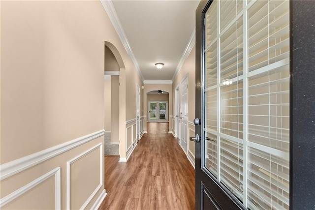 corridor featuring ornamental molding, french doors, and hardwood / wood-style flooring