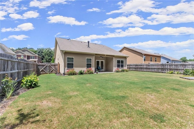 back of house with a patio area and a yard