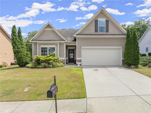 craftsman inspired home featuring a garage and a front lawn