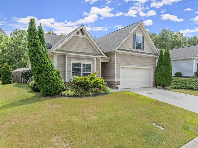 view of front of home with a front lawn and a garage