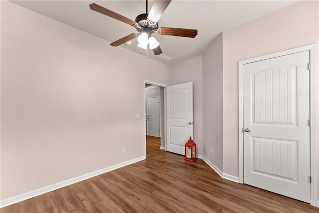 unfurnished bedroom with hardwood / wood-style flooring and ceiling fan