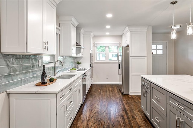 437 Valley Brook Dr NE, Atlanta, GA 30342 - kitchen featuring appliances with stainless steel finishes, dark wood-style floors, gray cabinetry, decorative backsplash, and plenty of natural light