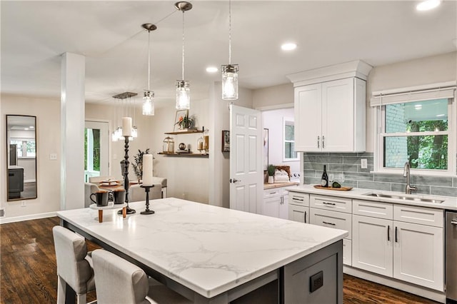 437 Valley Brook Dr NE, Atlanta, GA 30342 - kitchen featuring a center island, white cabinets, dark wood-style floors, hanging light fixtures, and recessed lighting