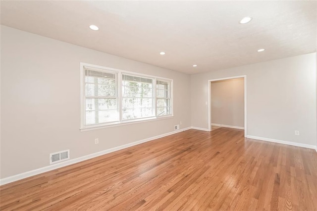 spare room with recessed lighting, baseboards, visible vents, and light wood finished floors