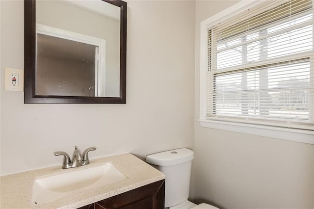 half bath featuring toilet and vanity