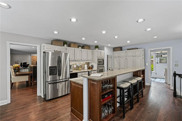 3648 Sope Creek Farm SE, Marietta, GA 30067 - kitchen with appliances with stainless steel finishes, light stone countertops, dark wood-style floors, recessed lighting, and white cabinetry