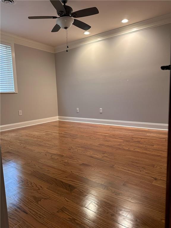 1055 Worthington Hills Dr, Roswell, GA 30076 - spare room featuring wood finished floors, a ceiling fan, crown molding, and baseboards