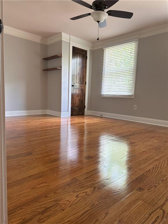 1055 Worthington Hills Dr, Roswell, GA 30076 - unfurnished room with ornamental molding, wood finished floors, ceiling fan, and baseboards