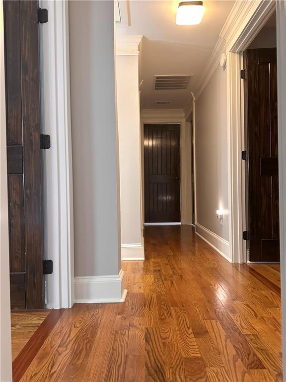 1055 Worthington Hills Dr, Roswell, GA 30076 - corridor featuring crown molding, baseboards, and wood finished floors