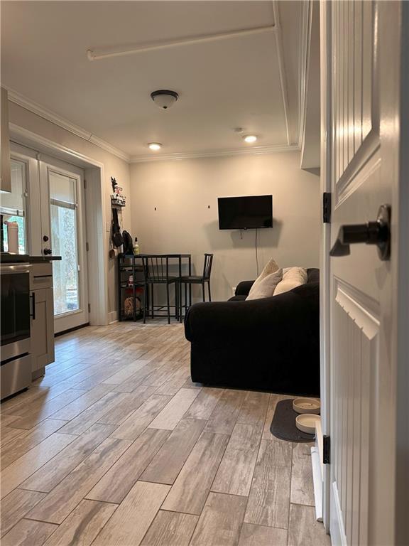1055 Worthington Hills Dr, Roswell, GA 30076 - living room featuring crown molding, light wood-style flooring, french doors, and recessed lighting