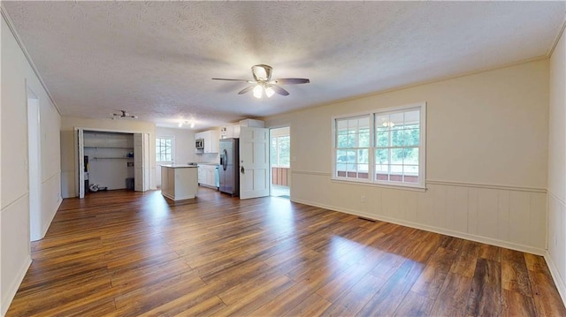 25 Forrest Ln, Cartersville, GA 30121 - unfurnished living room featuring ceiling fan, dark wood-style floors, a textured ceiling, and a wainscoted wall