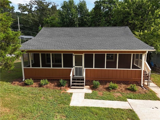 25 Forrest Ln, Cartersville, GA 30121 - view of front of house with a sunroom, a front yard, and a shingled roof