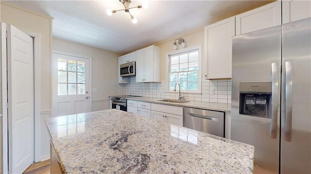 25 Forrest Ln, Cartersville, GA 30121 - kitchen featuring appliances with stainless steel finishes, tasteful backsplash, white cabinetry, light stone countertops, and a chandelier