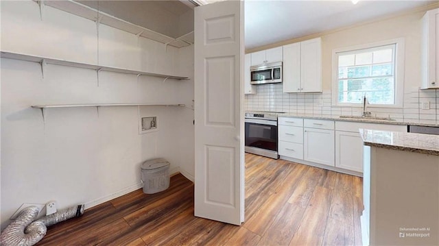 25 Forrest Ln, Cartersville, GA 30121 - kitchen with stainless steel microwave, light wood finished floors, light stone countertops, and backsplash