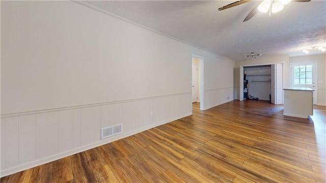 25 Forrest Ln, Cartersville, GA 30121 - unfurnished room featuring wood finished floors, ceiling fan, a textured ceiling, wainscoting, and crown molding