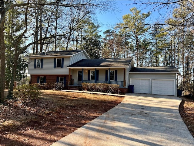 split level home featuring a porch and a garage