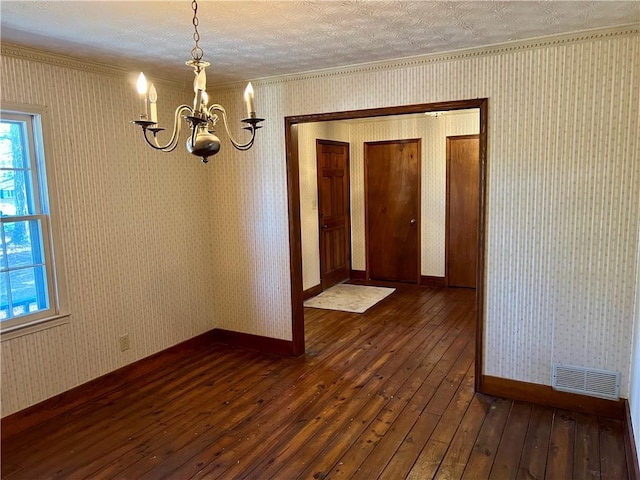 unfurnished dining area with dark wood-type flooring and a chandelier