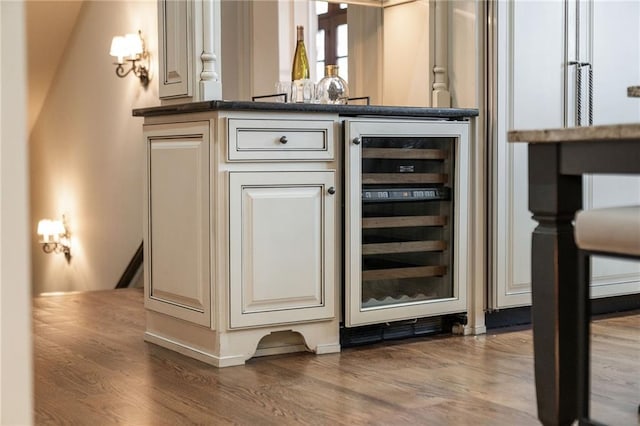 bar featuring a dry bar, beverage cooler, and wood finished floors