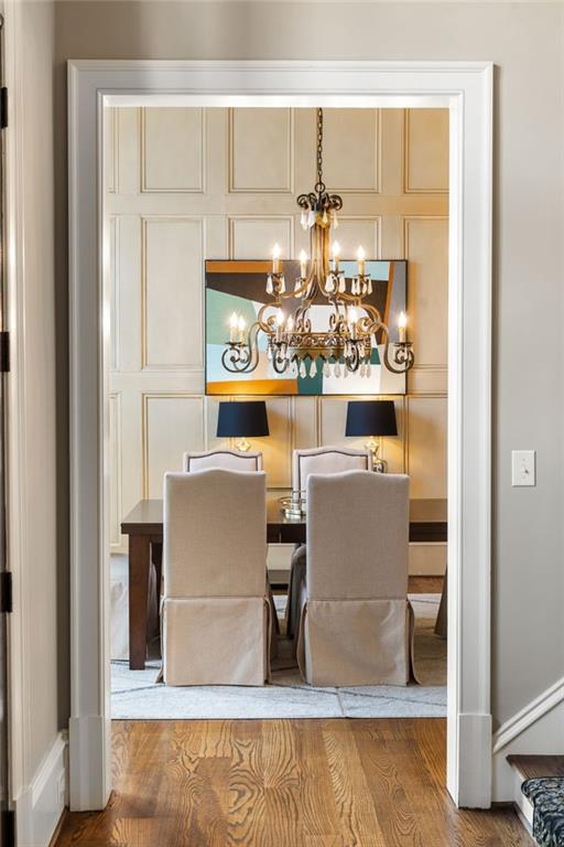 dining space featuring a notable chandelier and wood finished floors