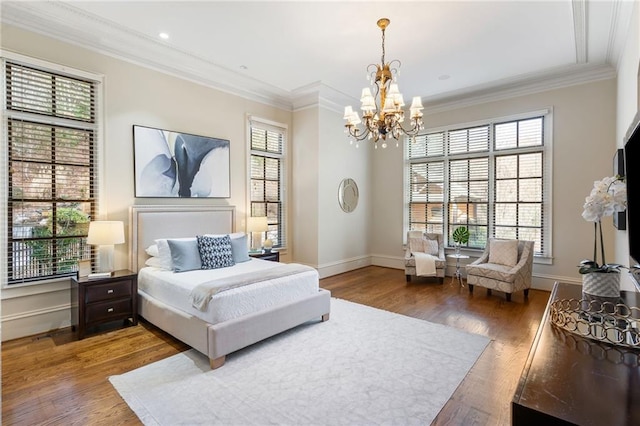 bedroom with a chandelier, ornamental molding, wood finished floors, and baseboards