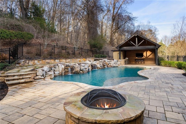 view of swimming pool with a patio area, fence, a fire pit, and a fenced in pool