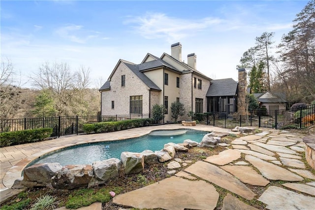 view of pool featuring fence, a fenced in pool, and a patio